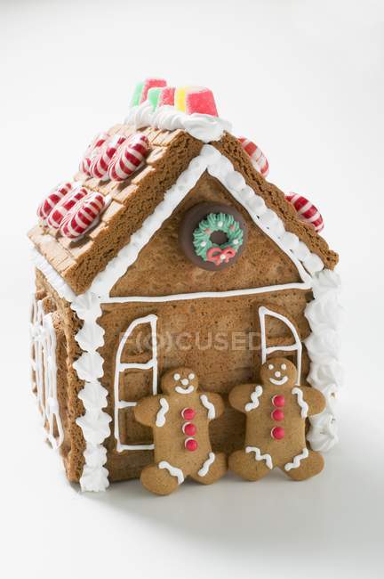 Gingerbread house with men — Stock Photo