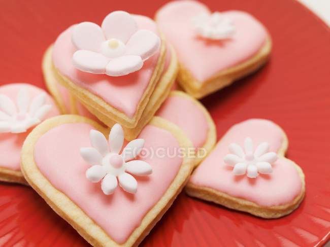 Sugar flowers on red plate — Stock Photo