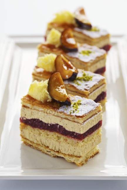 Closeup view of chestnut and plum cake pieces on plate — Stock Photo