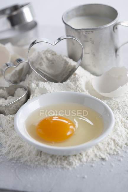 Closeup view of baking ingredients and heart-shaped cutters — Stock Photo