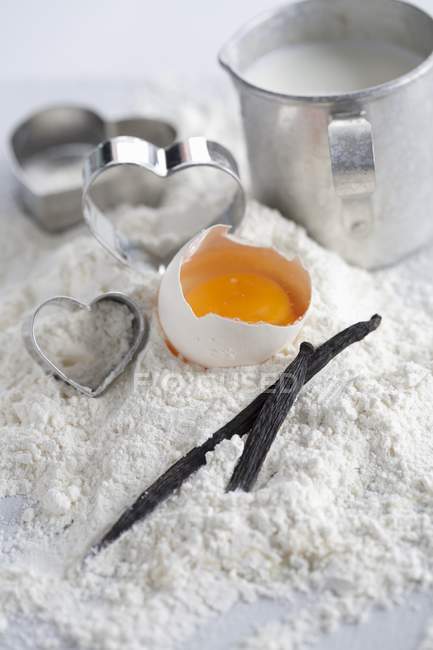 Closeup view of baking ingredients and heart-shaped cutters — Stock Photo