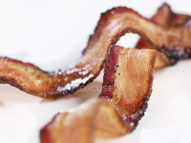Pieces of Crispy Pepper Bacon — Stock Photo