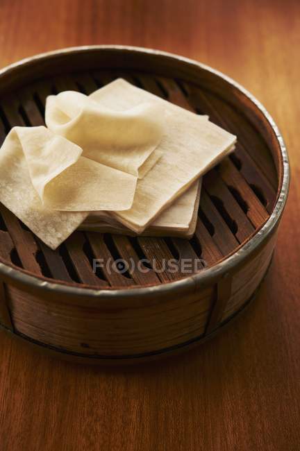 Closeup view of Wonton wrappers stacked on steamer — Stock Photo