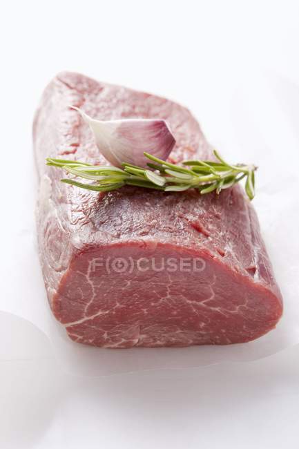 Fillet of beef with rosemary and garlic clove — Stock Photo