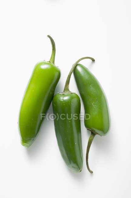 Three green chillies — Stock Photo