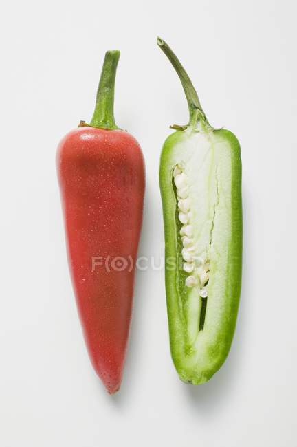 Whole red and half green chillies — Stock Photo