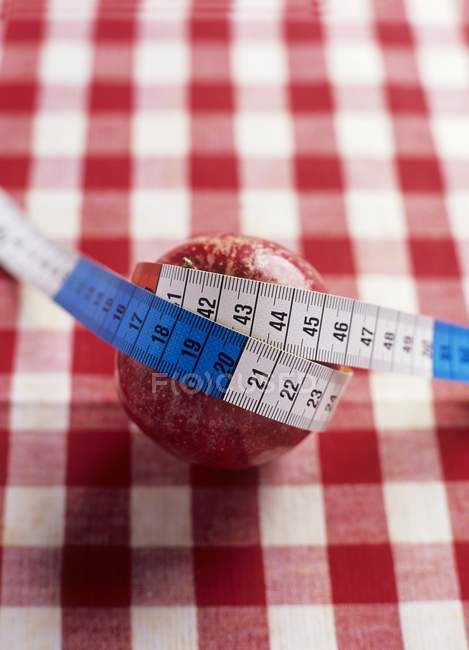 Pomme rouge avec ruban à mesurer — Photo de stock