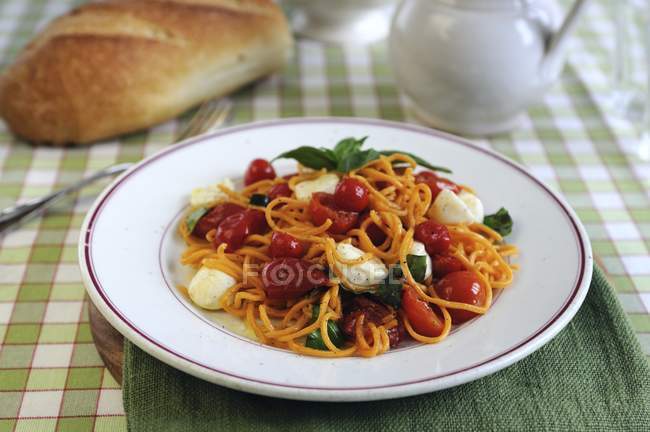 Espaguetis con tomates cherry y mozzarella - foto de stock