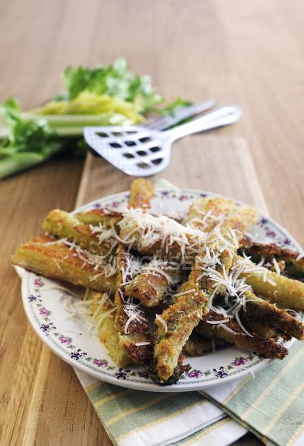 Fried celery with Parmesan — Stock Photo