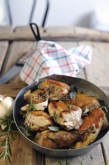 Closeup view of fried Guinea fowl with rosemary and sage — Stock Photo