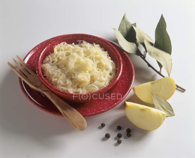 Apple sauerkraut in a dish  on white surface — Stock Photo