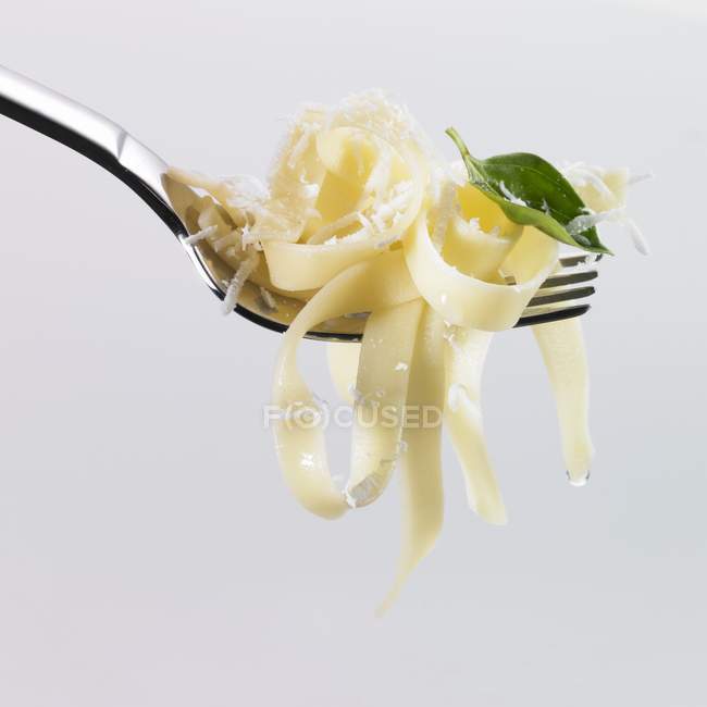Tagliatelle pasta with basil and grated Parmesan — Stock Photo