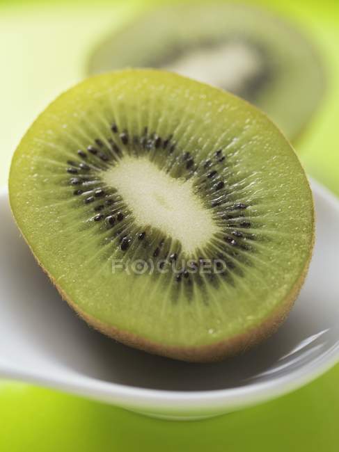 Kiwi on white spoon — Stock Photo