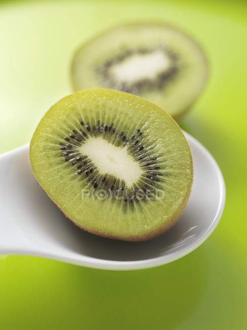 Kiwi on white spoon — Stock Photo