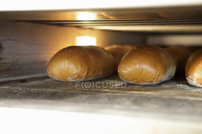 Bread in baking oven — Stock Photo