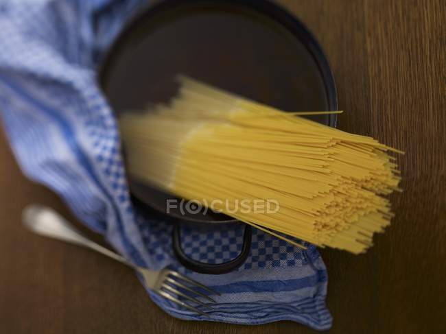 Bundle of spaghetti in water — Stock Photo