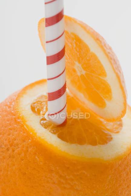 Orange fruit with straw — Stock Photo