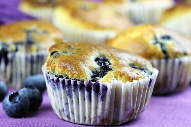 Blueberry muffins on table cloth — Stock Photo
