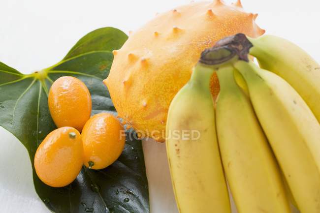 Banana with kiwano and kumquats — Stock Photo