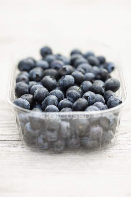 Blueberries in plastic container — Stock Photo