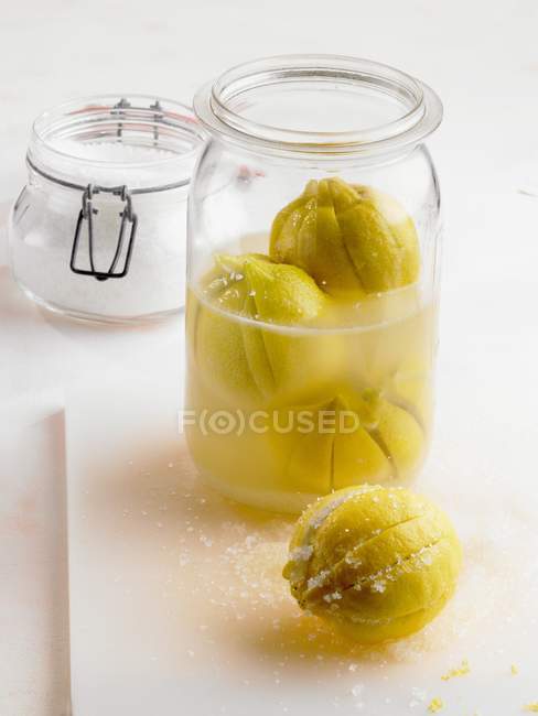 Salt-pickled lemons in jar — Stock Photo
