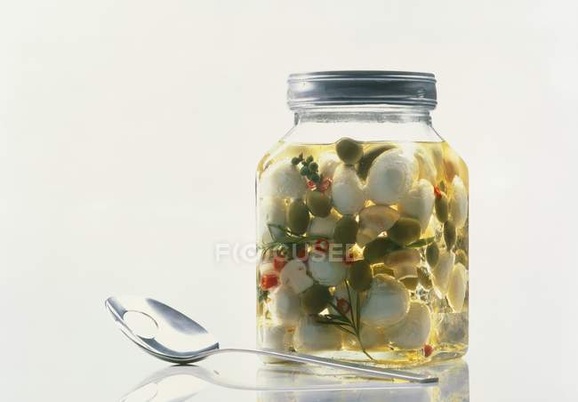 Mushrooms and olives in oil — Stock Photo