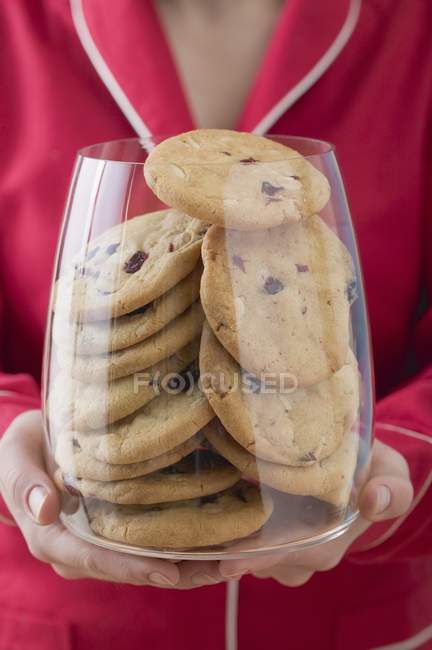 Woman holding glass of cookies — Stock Photo