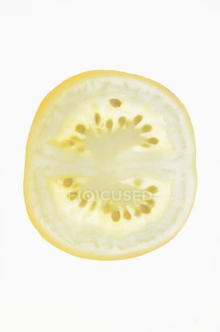 Slice of yellow tomato — Stock Photo