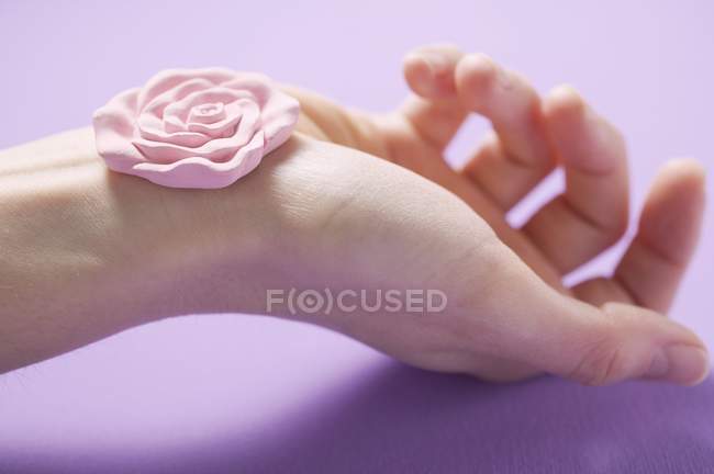 Closeup view of rose pink soap on female hand — Stock Photo