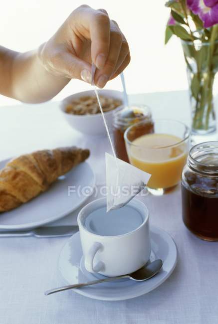 Breakfast with tea and croissant — Stock Photo