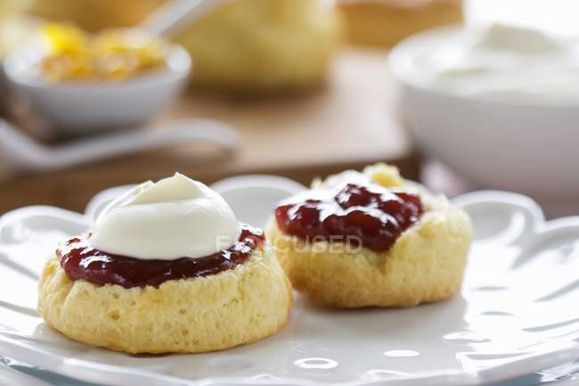 Scones with cream and jam — Stock Photo