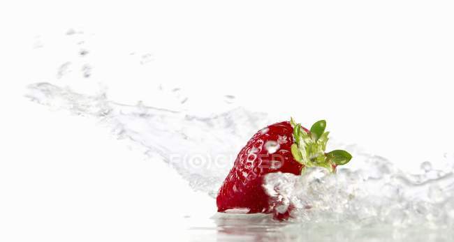 Strawberry with splashing water — Stock Photo