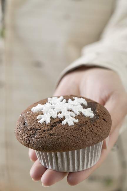 Main tenant muffin au chocolat — Photo de stock