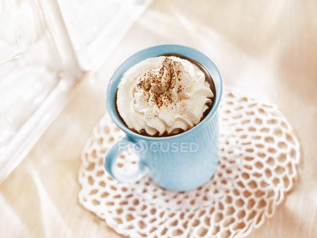 Closeup view of chocolate drink with cream topping — Stock Photo