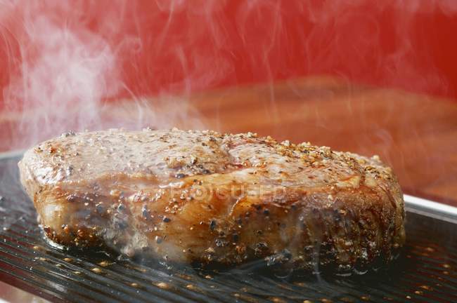 Grilling peppered steak — Stock Photo
