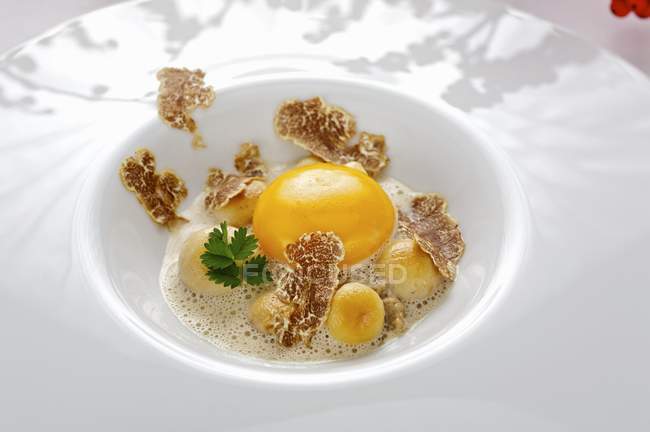 Raw egg with truffle and button mushrooms — Stock Photo