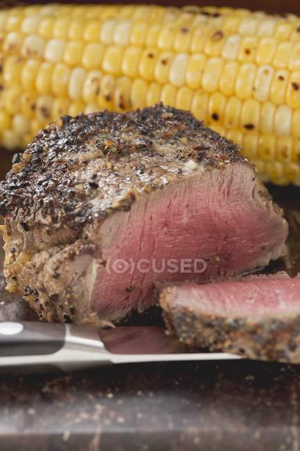 Peppered steak with corn — Stock Photo