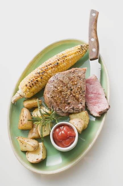 Peppered steak with corn — Stock Photo