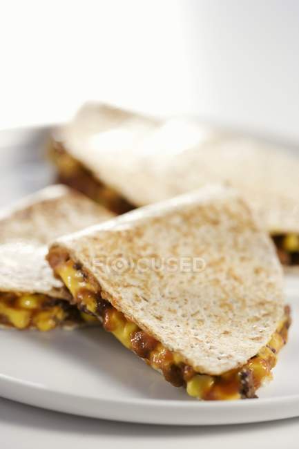 Closeup view of Quesadillas on a white plate — Stock Photo