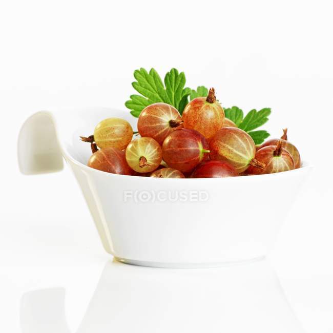 Fresh gooseberries in dish — Stock Photo