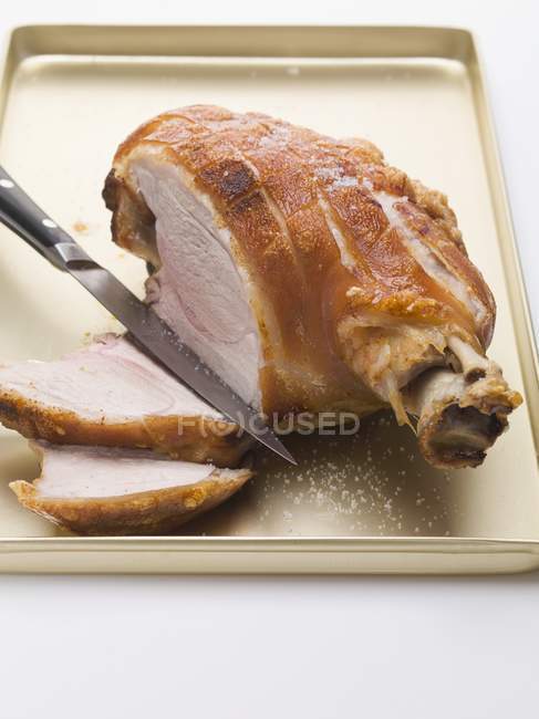 Partly sliced Roasted pork with crackling — Stock Photo