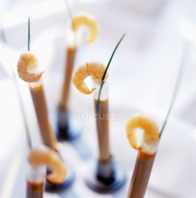 Closeup view of shellfish soup with scampi in test tubes — Stock Photo