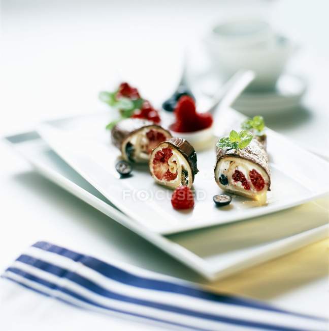 Closeup view of raspberry Cannelloni with a nut cream coating — Stock Photo