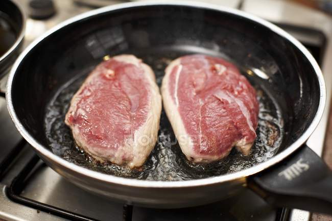 Frying duck breasts — Stock Photo
