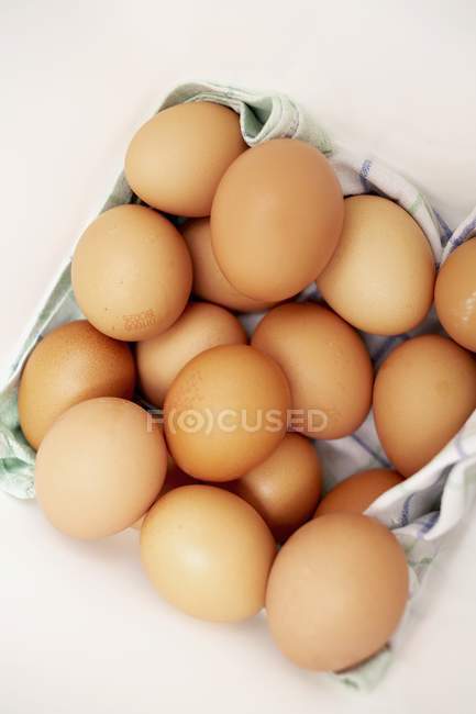 Organic eggs on towel — Stock Photo