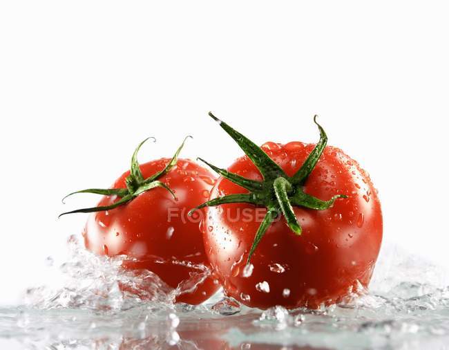 Due pomodori circondati da acqua — Foto stock