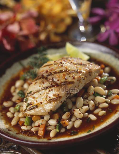 Grilled fish fillet on bean sauce on plate — Stock Photo