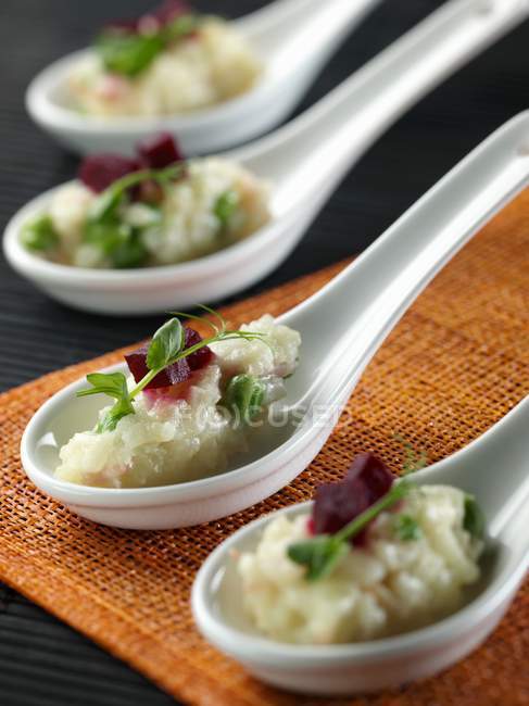 Spoons full of ham and risotto — Stock Photo