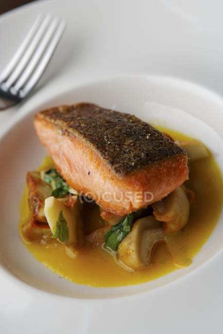 Closeup view of sea trout with lobster mushrooms — Stock Photo