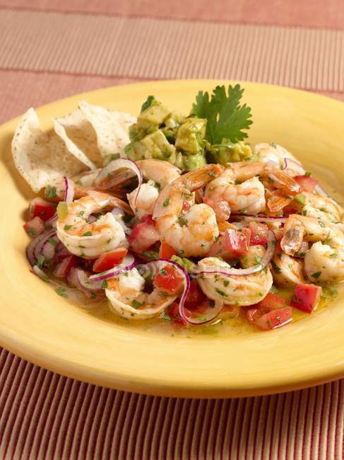Shrimp Ceviche on yellow plate with vegetables — Stock Photo